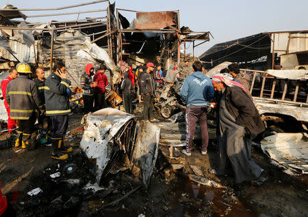 Firemen and people gather at the site of a car bomb attack at a vegetable market in eastern Baghdad, Iraq, January 8, 2017. REUTERS/Wissm al-Okili