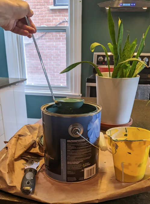a ladle in a paint can