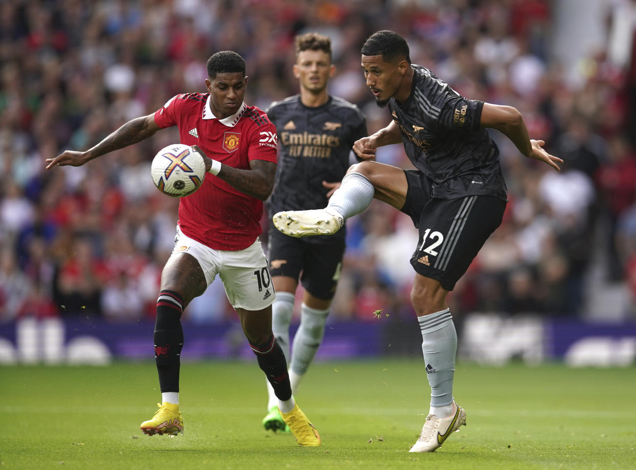 Arsenal's William Saliba, right, challenges for the ball with Manchester United's Marcus Rashford during the English Premier League soccer match between Manchester United and Arsenal at Old Trafford stadium, in Manchester, England, Sunday, Sept. 4, 2022. (AP Photo/Dave Thompson)