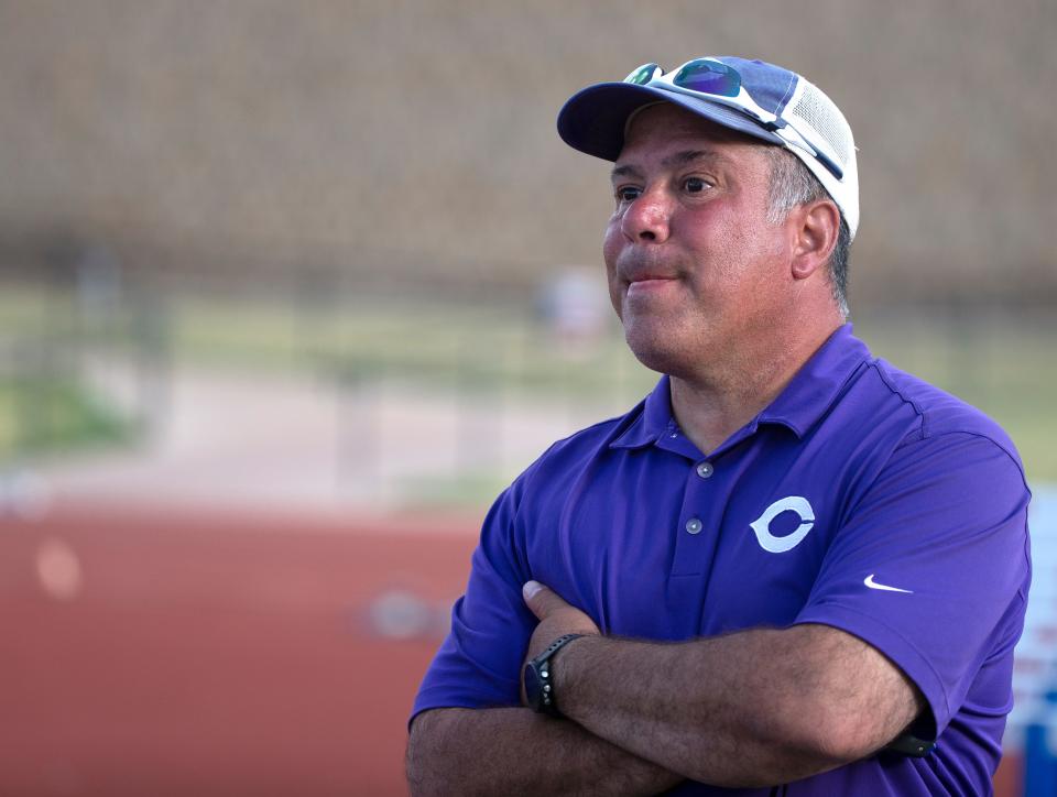 Canyon's head track coach Ray Baca watches the 4x400 meter relay, Thursday, April 21, 2022, at Lowrey Field at PlainsCapital Park.