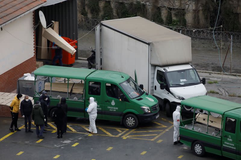 Funeral vehicles stand in front of a morgue to carry coffins of coronavirus disease victims to a cemetery in Istanbul