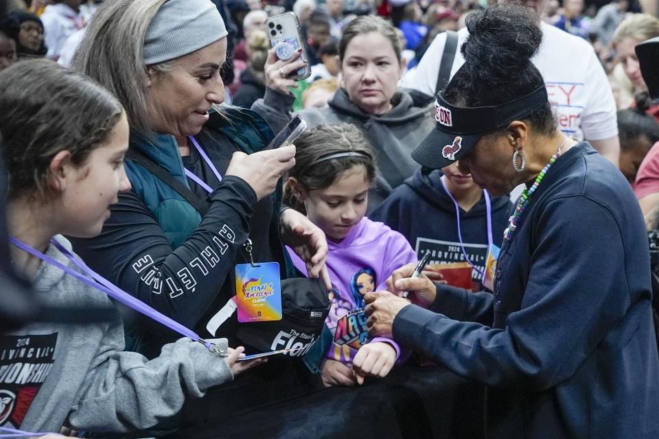 South Carolina head coach Dawn Staley signs autographs for fans during practice for the NCAA Women's Final Four championship basketball game Saturday, April 6, 2024, in Cleveland. (AP Photo/Morry Gash)