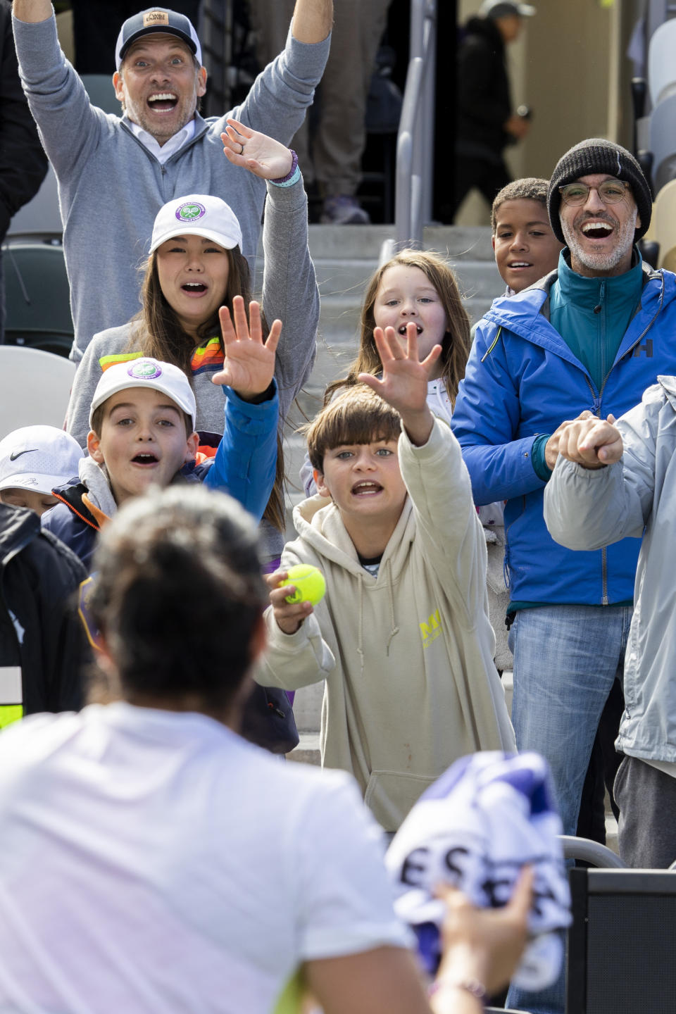 Ons Jabeur, of Tunisia, prepares to throw her towel to screaming fans after defeating Belinda Bencic, of Switzerland, during the championship match at the Charleston Open tennis tournament in Charleston, S.C., Sunday, April 9, 2023. (AP Photo/Mic Smith)