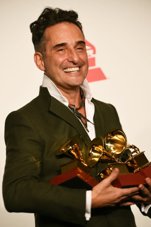 Uruguayan musician Jorge Drexler poses with his awards at the Latin Grammys in Las Vegas