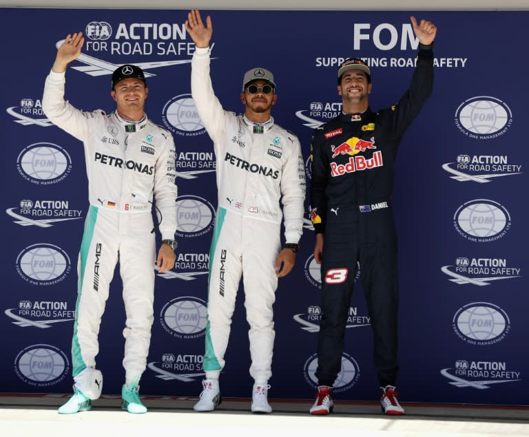 Top three qualifiers Lewis Hamilton of Mercedes GP, Nico Rosberg of Mercedes GP and Daniel Ricciardo of Red Bull Racing wave to the crowd in parc ferme during qualifying for the United States Formula One Grand Prix at Circuit of The Americas