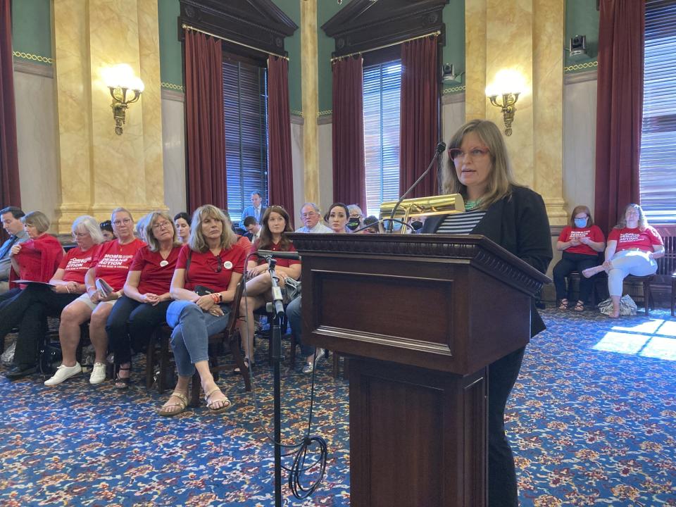 Erin Gabbard, an opponent of GOP legislation that would permit Ohio school districts to arm employees by creating training standards, testifies against the latest version of the bill on Tuesday, May 31, 2022, in Columbus, Ohio. Gabbard was one of the parents at Madison local schools in southwestern Ohio who successfully sued in 2018 over the district's training requirements, arguing they should be much higher. (AP Photo/Andrew Welsh-Huggins)