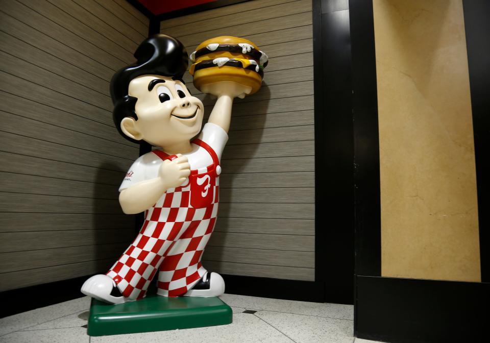 All you need for an iconic Frisch's Big Boy costume is a white T-shirt that says "big boy," red and white checkered overalls, black shoes and a burger in your hand.