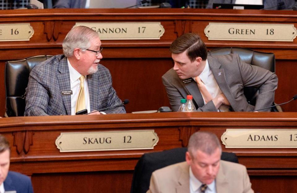 Rep. Bruce Skaug, R-Nampa, left, speaks with and Rep. Ben Adams, R-Nampa, during the 2022 House session.