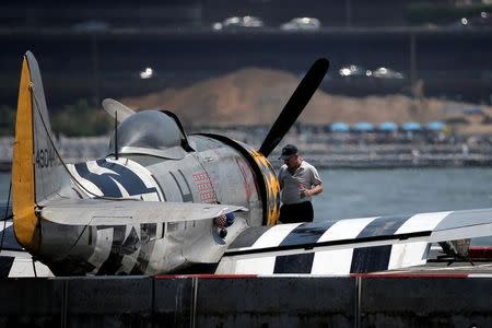 FAA investigators look over the wreckage of a vintage P-47 Thunderbolt airplane that crashed in the Hudson River in New York City, New York, U.S. May 28, 2016. REUTERS/Brendan McDermid