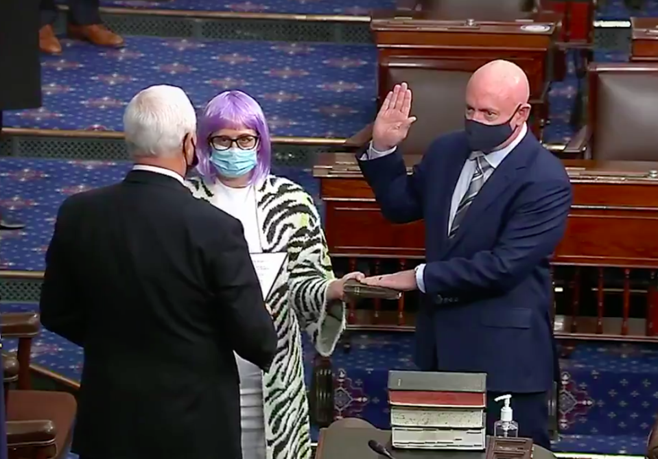 Senator Mark Kelly is sworn-in by Vice President Mike Pence while Senator Kyrsten Sinema holds a Bible on the Senate floor on December 2, 2020. / Credit: Senate TV