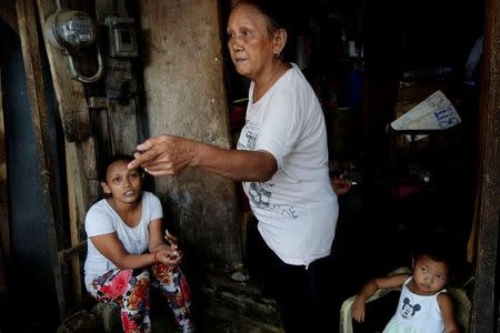 Clarita Alia, 62, talks at her home about her four sons which have died in execution-style killings in Davao, Philippines May 14, 2016. REUTERS/Andrew RC Marshall