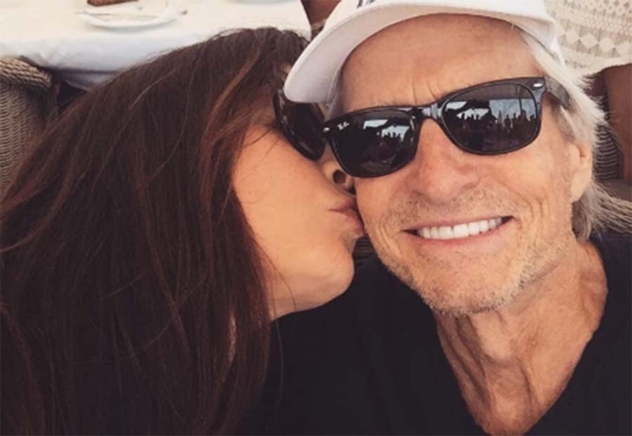 Catherine Zeta Jones gives Michael Douglas a joint birthday kiss