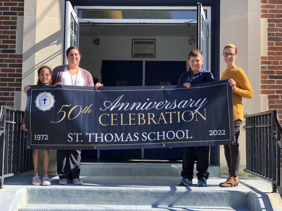 St. Thomas School will celebrate 50 years of providing Catholic education in Sanford, Maine, this Sunday, Oct. 23, 2022. Seen here on the school's front steps one recent morning are fourth-grader Lilah Murphy, left, Principal Jessica Rice, fourth-grader Alex Labbe, and Ericka Sanborn, the school's director of legacy, marketing and enrollment.