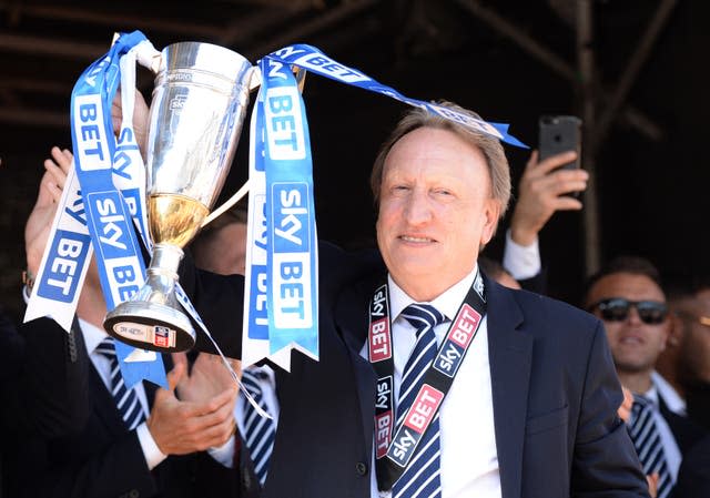 Neil Warnock celebrates guiding Cardiff into the Premier League