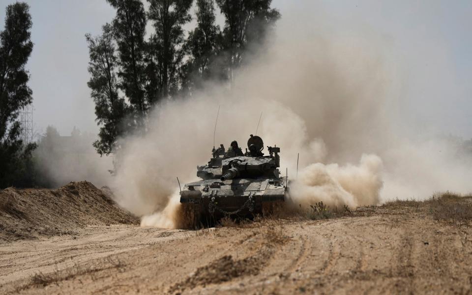 An Israeli tank moves near the Gaza Strip border