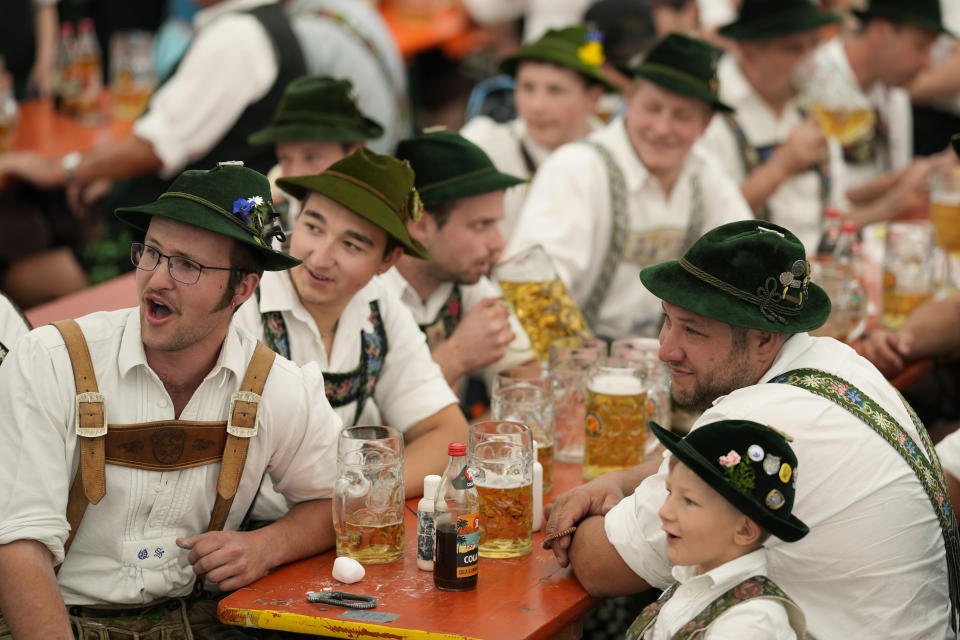 People dressed in traditional clothes attend the German Championships in Fingerhakeln or finger wrestling, in Bernbeuren, Germany, Sunday, May 12, 2024. Competitors battled for the title in this traditional rural sport where the winner has to pull his opponent over a marked line on the table. (AP Photo/Matthias Schrader)