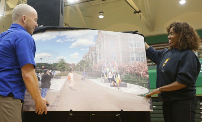 Former Olympic Gold Medalist Jacki Joyner-Kersee and former Olympic speed skater Brendan Eppert unveil an artist's rendition at Washington University in St. Louis on February 5 after it was announced that an Olympic Legacy Committee has been formed that will remember the Summer Olympics that were held at the campus in 1904. File Photo by Bill Greenblatt/UPI