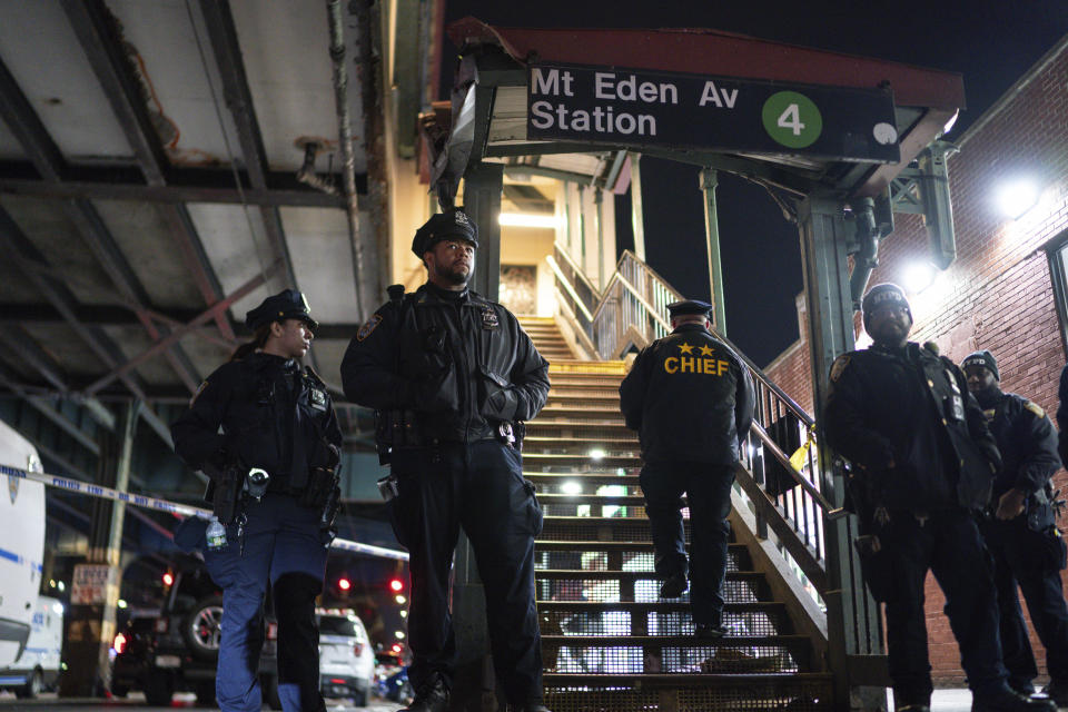 FILE - New York City Police officers stand guard following a shooting at the Mount Eden subway station, Monday, Feb. 12, 2024, in the Bronx borough of New York. The New York Police Department has been taking a more active role in trying to influence public policy through slick online videos and social media posts. (AP Photo/Eduardo Munoz Alvarez, File)