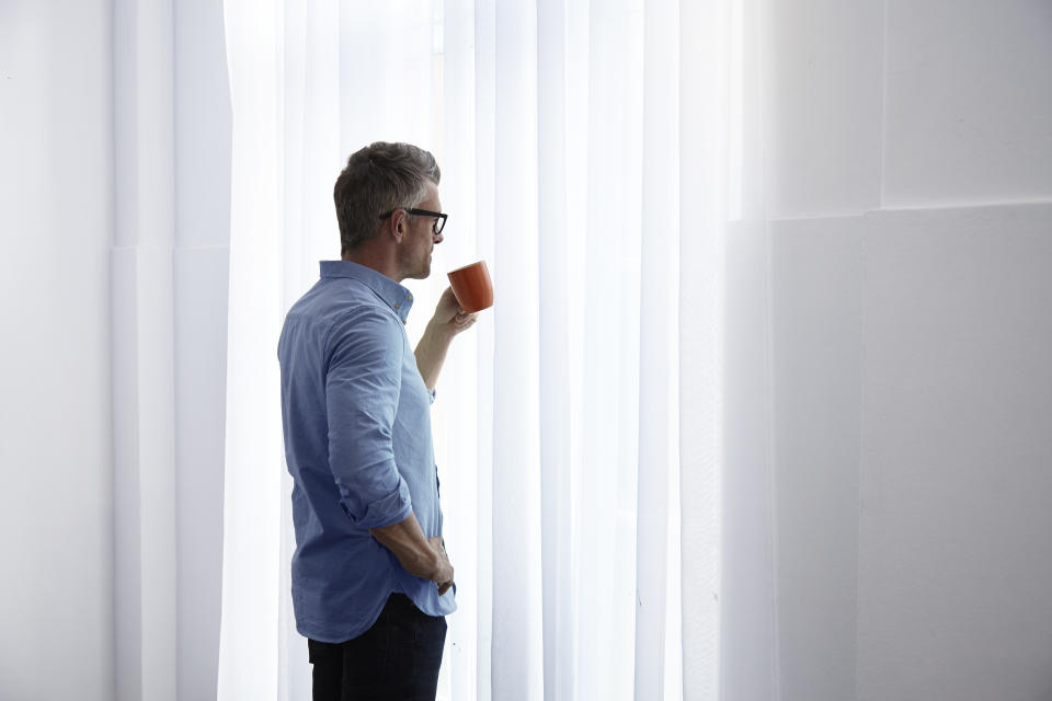 Man looking sad out the window. (Getty Images)