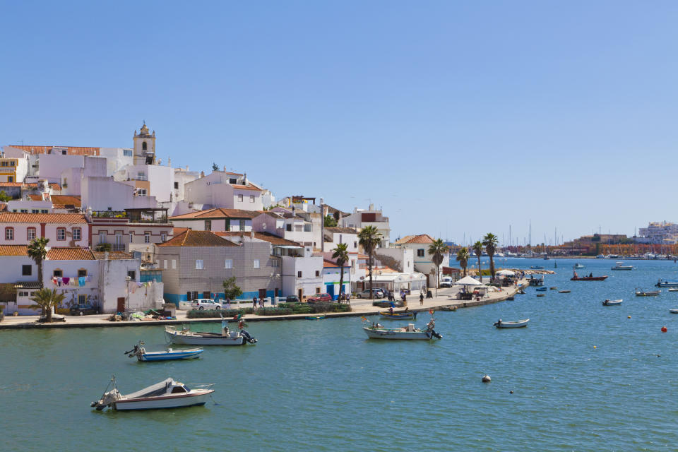 Fishing boats in the water near Portimao, Algarve, Portugal.