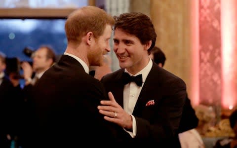 Britain's Prince Harryspeaks with Canadian Prime Minister Justin Trudeau during a reception in April 2018 - Credit: Matt Dunham/AP