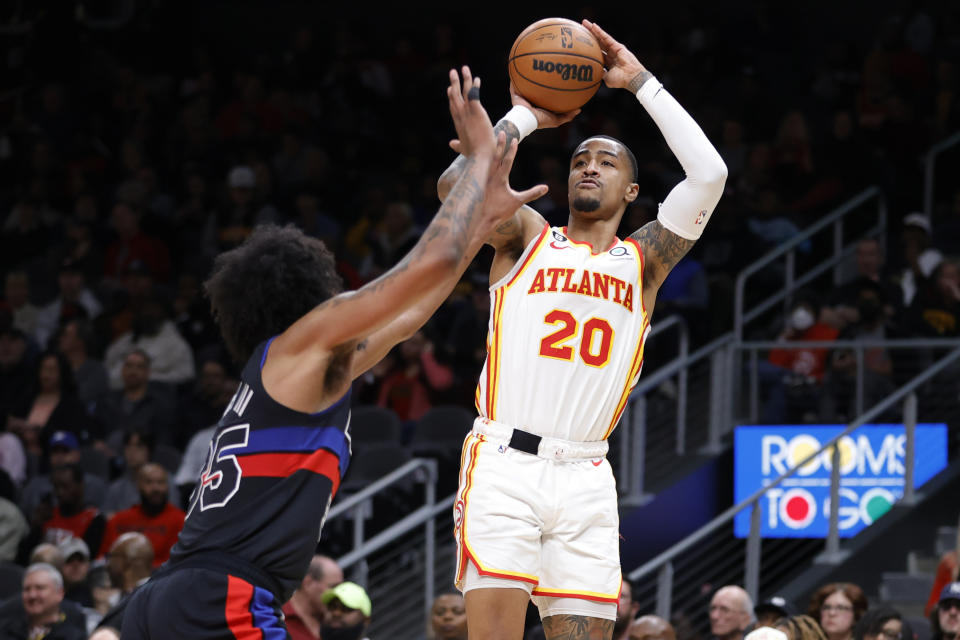 Atlanta Hawks forward John Collins shoots over Detroit Pistons forward Marvin Bagley III, left, during the first half of an NBA basketball game Tuesday, March 21, 2023, in Atlanta. (AP Photo/Alex Slitz)