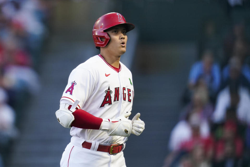 Los Angeles Angels designated hitter Shohei Ohtani (17) returns to the dugout after flying out to right field during the first inning of a baseball game against the Tampa Bay Rays in Anaheim, Calif., Monday, May 9, 2022. (AP Photo/Ashley Landis)