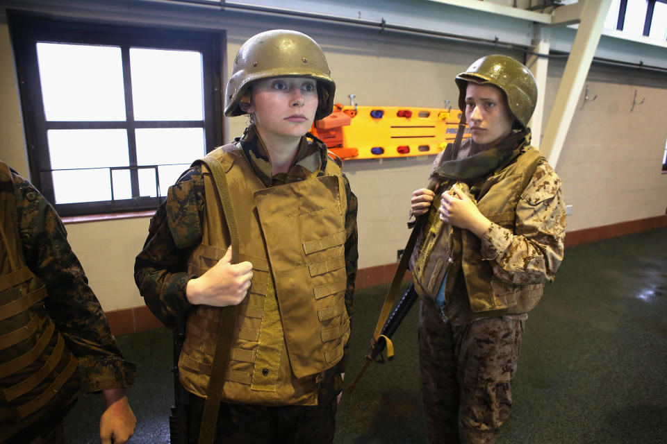 PARRIS ISLAND, SC - FEBRUARY 25: Female Marine recruits Kara Forrestor (L) of Great Falls, Montana and Savannah Warren of Deer Park, Washington prepare to jump in the pool wearing body armor for swim training during boot camp February 25, 2013 at MCRD Parris Island, South Carolina. Male and female Marines are expected to meet the same standards during their swim qualification testing. All female enlisted Marines and male Marines who were living east of the Mississippi River when they were recruited attend boot camp at Parris Island. About six percent of enlisted Marines are female. (Photo by Scott Olson/Getty Images)