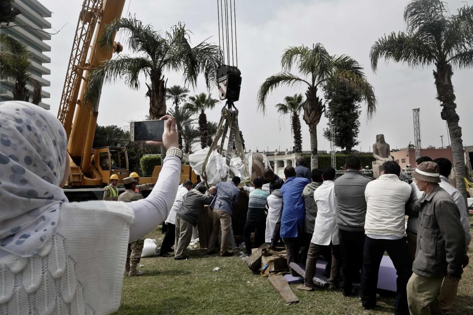 Antiquities workers bring down stone parts of the statue of King Psamtek l at the Egyptian museum in Cairo, Thursday, March 16, 2017. Egypt's antiquities minister Khaled el-Anani, told at a news conference that the colossus discovered last week in an eastern Cairo suburb almost certainly depicts Psamtek I, who ruled Egypt between 664 and 610 B.C. (AP Photo/Nariman El-Mofty)