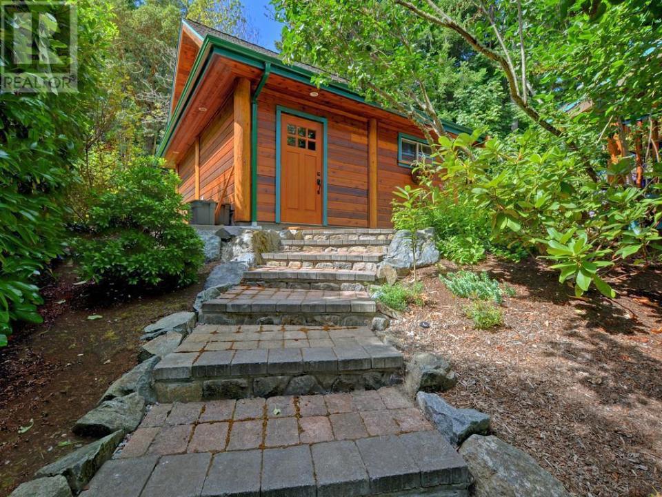 <p><span>8701 Griggs Terrace, North Saanich, B.C.</span><br> The home sits on 0.57 acres, has plenty of natural landscaping, and has a two-car detached garage.<br> (Photo: Zoocasa) </p>