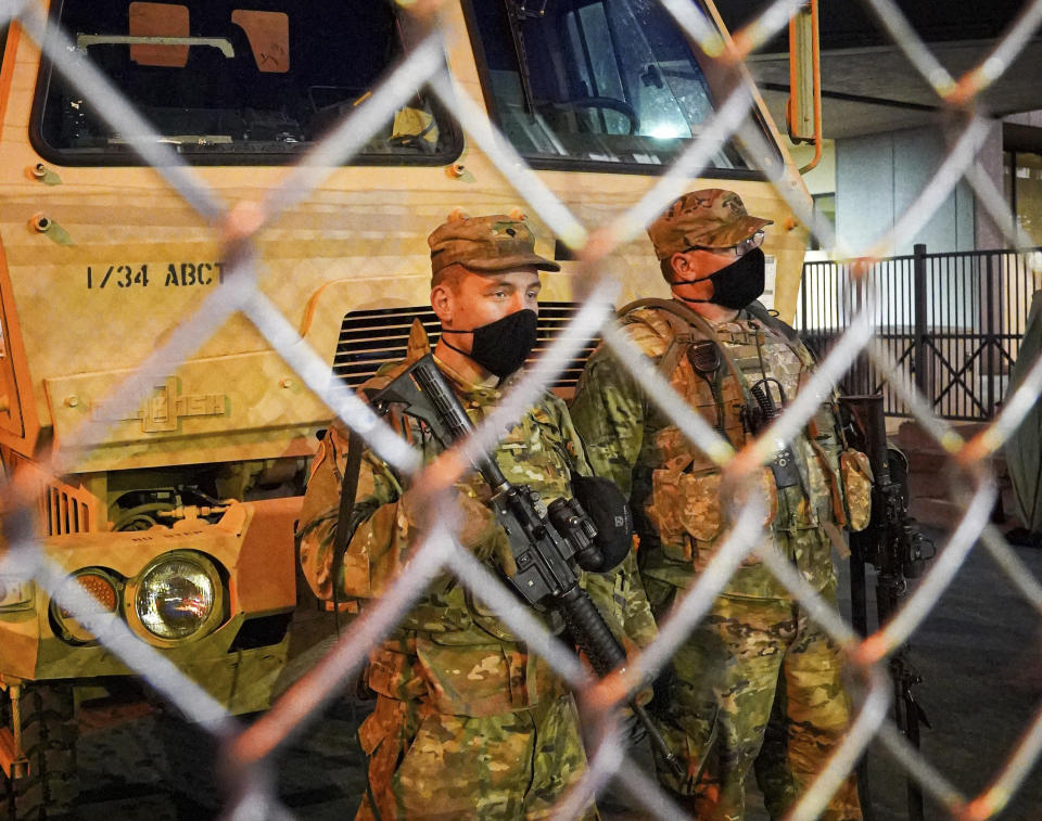 National Guard troops watch the pedestrian entrance Monday, March 8, 2021, at the Hennepin County Courthouse in Minneapolis, Minn., the site of the trial of former Minneapolis police officer Derek Chauvin in the death of George Floyd. (Glen Stubbe/Star Tribune via AP)