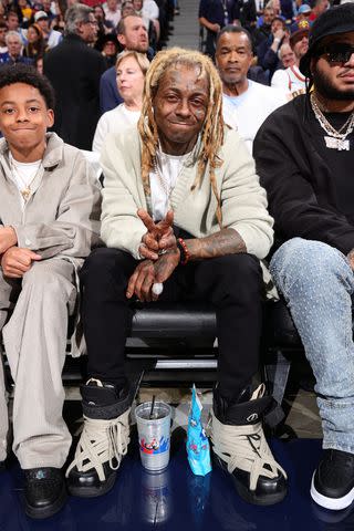 <p>Nathaniel S. Butler/NBAE via Getty</p> Lil Wayne and son Kameron