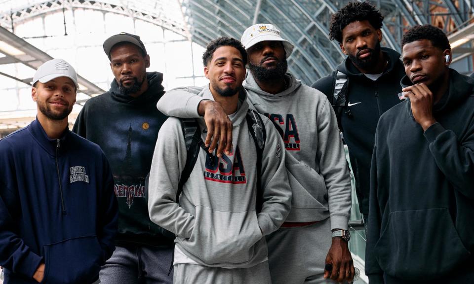 <span>Stephen Curry, Kevin Durant, Tyrese Haliburton, Lebron James, Joel Embiid, and Anthony Edwards prepare to board the Eurostar from London to Paris for the Olympics. </span><span>Photograph: Benjamin Cremel/AFP/Getty Images</span>