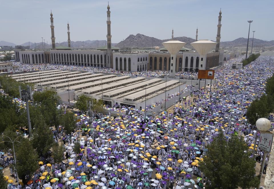 Muslim pilgrims move on their way to perform Friday Prayers at Namira Mosque in Arafat, on the second day of the annual hajj pilgrimage, near the holy city of Mecca, Saudi Arabia, Friday, July 8, 2022. (AP Photo/Amr Nabil)