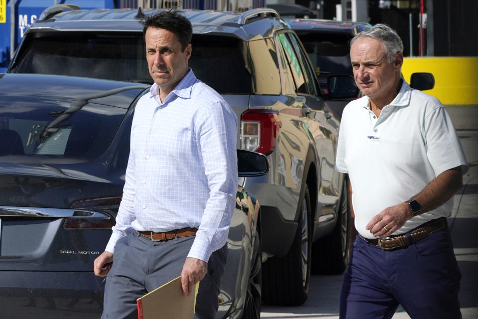 Major League Baseball Deputy Commissioner Dan Halem, left, and Commissioner Rob Manfred, right, walk after negotiations with the players association in an attempt to reach an agreement to salvage March 31 openers and a 162-game season, Monday, Feb. 28, 2022, at Roger Dean Stadium in Jupiter, Fla. (AP Photo/Lynne Sladky)