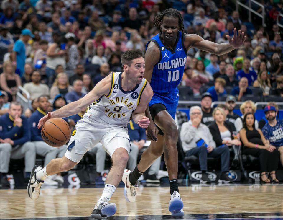 Indiana Pacers guard T.J. McConnell (9) drives against Orlando Magic center Bol Bol (10) during the first half of an NBA basketball game Saturday, Feb. 25, 2023, in Orlando, Fla. (AP Photo/Alan Youngblood)