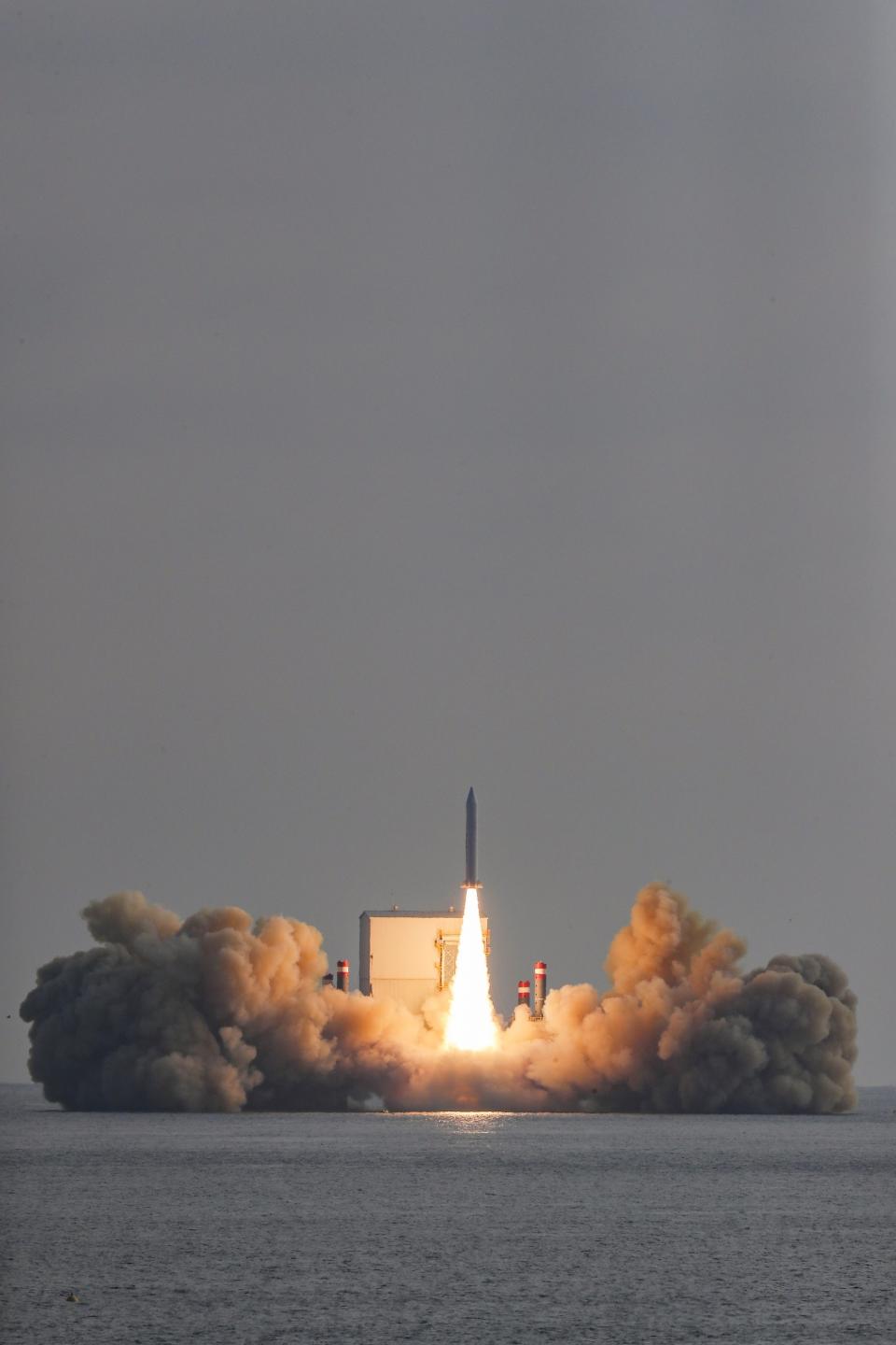 In this photo provided by South Korea Defense Ministry, the third test flight of solid-fuel space rocket is launched from a barge in waters near Jeju Island, South Korea, Monday, Dec. 4, 2023. (South Korea Defense Ministry via AP)