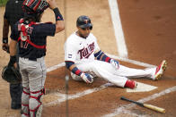 Minnesota Twins' Nelson Cruz has a hard landing after avoiding a close pitch from Cleveland Indians pitcher J.C. Mejia in the first inning of a baseball game, Thursday, June 24, 2021, in Minneapolis (AP Photo/Jim Mone)