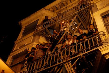 People watch a street celebration from a balcony in San Francisco, California October 29, 2014. REUTERS/Stephen Lam