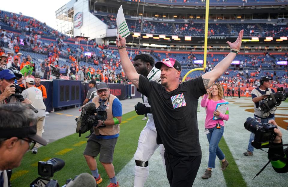 Jets offensive coordinator Nathaniel Hackett celebrates Sunday's 31-21 victory over the Broncos in Denver.