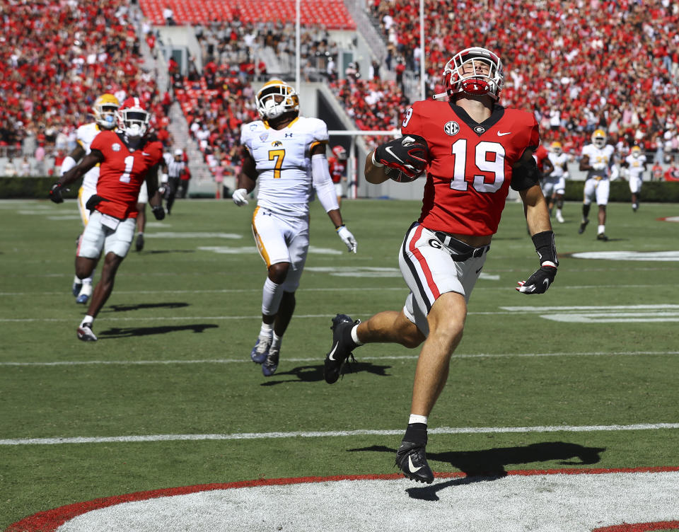 FILE - Georgia tight end Brock Bowers breaks away from Kent State safety Antwaine Richardson on a 70-plus yard touchdown during an NCAA college football game Saturday, Sept. 24, 2022 ,in Athens Ga. Georgia will begin its drive for an unprecedented college football championship three-peat as the No. 1 team in The Associated Press preseason Top 25 in the poll released Monday, Aug. 14, 2023. (Curtis Compton/Atlanta Journal-Constitution via AP, File)