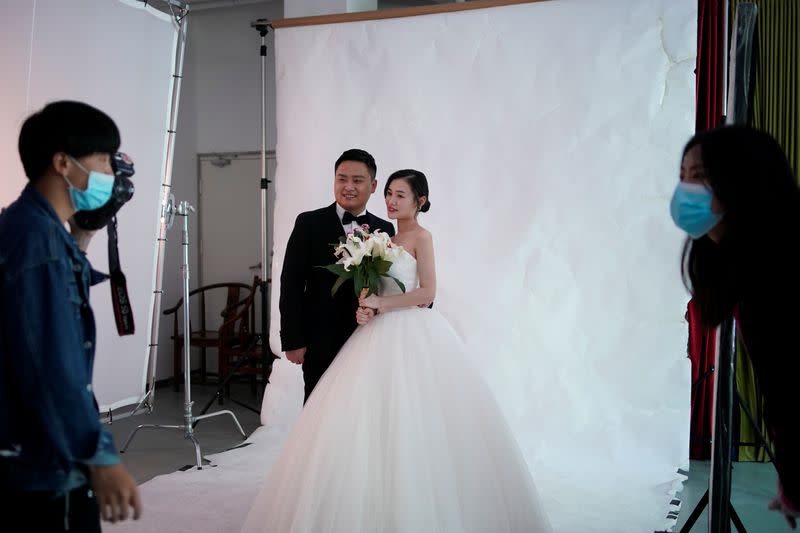 Peng Jing, 24, and Yao Bin, 28, pose for their wedding photography shoot after the lockdown was lifted in Wuhan