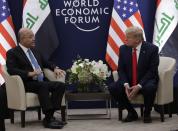 US President Donald Trump, right, attends a meeting with his Iraqi counterpart Barham Salih at the World Economic Forum in Davos, Switzerland, Wednesday, Jan. 22, 2020. Trump's two-day stay in Davos is a test of his ability to balance anger over being impeached with a desire to project leadership on the world stage. (AP Photo/Evan Vucci)
