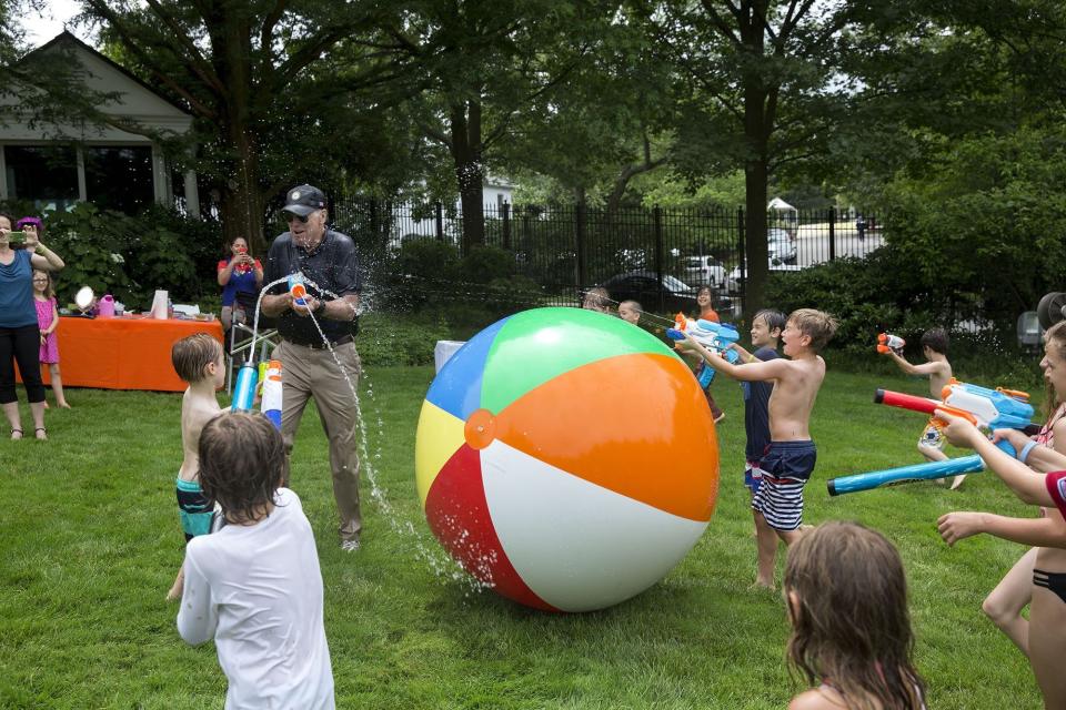 The vice president chases children and members of the press with a super soaker during the 2016 Biden Beach Boardwalk Bash at the Naval Observatory Residence in Washington, D.C., on June 4.