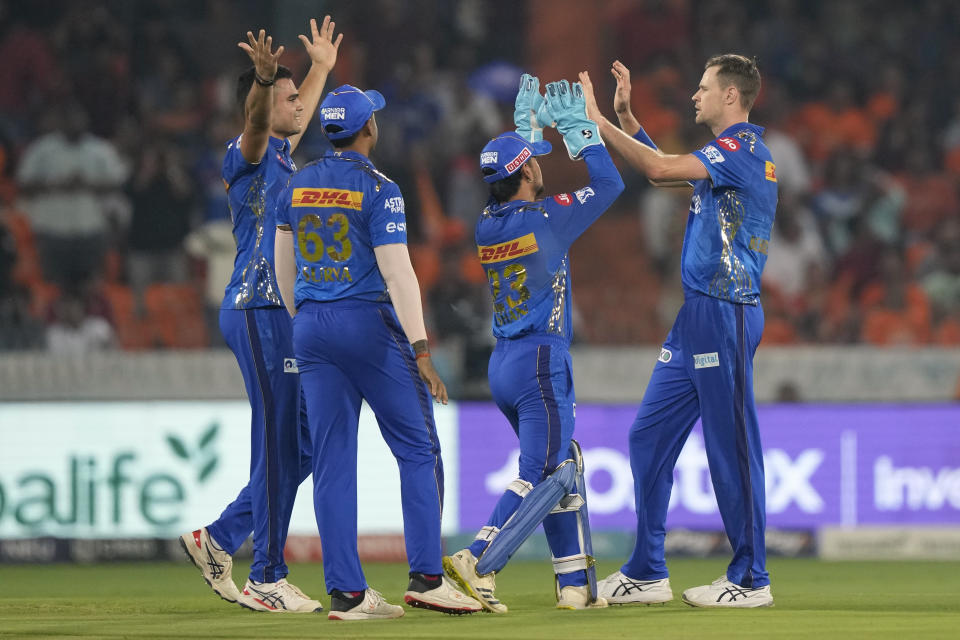Mumbai Indians' players celebrate the wicket of Sunrisers Hyderabad's Harry Brook during the Indian Premier League cricket match between Sunrisers Hyderabad and Mumbai Indians in Hyderabad, India, Tuesday, April 18, 2023. (AP Photo/Mahesh Kumar A.)