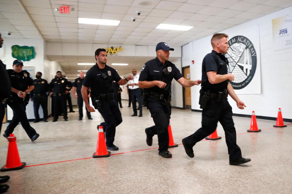 Savannah Police officers enter the STEM Academy at Bartlett while participating in an active shooter drill.