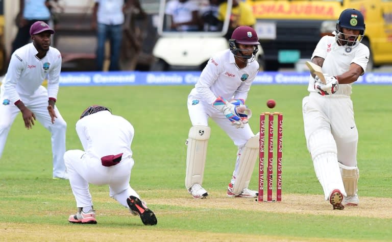 Batsman Shikhar Dhawan of India connects off a delivery from West Indies bowler Devendra Bishoo in the 18th over on July 30, 2016 in Kingston, Jamaica on the first day of the 2nd Test between India and the West Indies