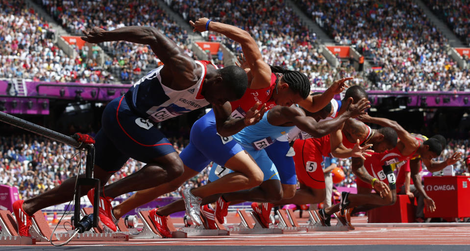 Britain's Dwain Chambers (L) starts his the men's 100m round 1 heats at the London 2012 Olympic Games at the Olympic Stadium August 4, 2012. REUTERS/Eddie Keogh (BRITAIN - Tags: OLYMPICS SPORT ATHLETICS) 