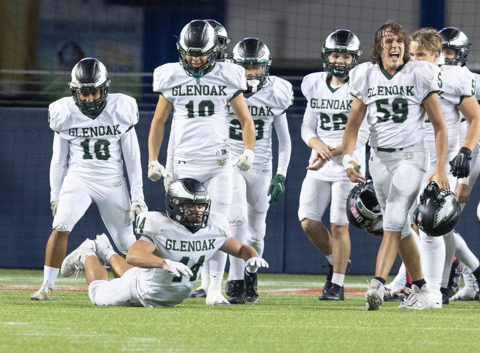 GlenOak's David Potter does "the worm" to celebrate their win at McKinley, Friday, Oct. 13, 2023.