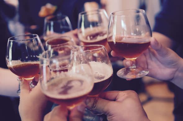 Group of people toasting with alcohol - Unsplash image
